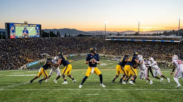 California Golden Bears quarterback Fernando Mendoza dropping back to throw a pass during a college football game.