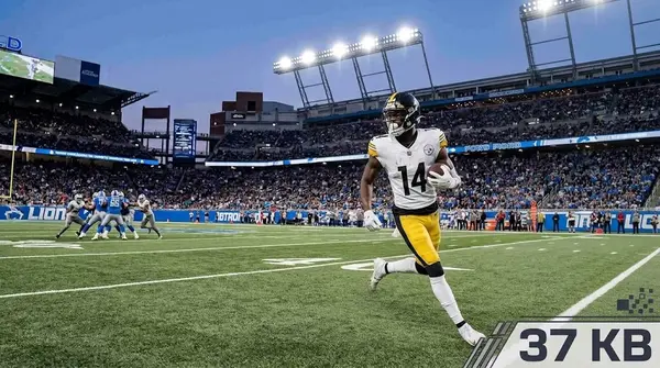 Pittsburgh Steelers wide receiver George Pickens (#14) running with the ball after a catch during an NFL game.