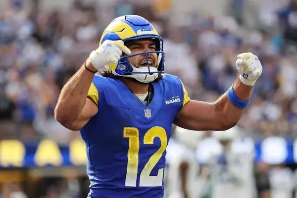 Los Angeles Rams wide receiver Puka Nacua wearing helmet and number 12 jersey celebrating during an NFL game.